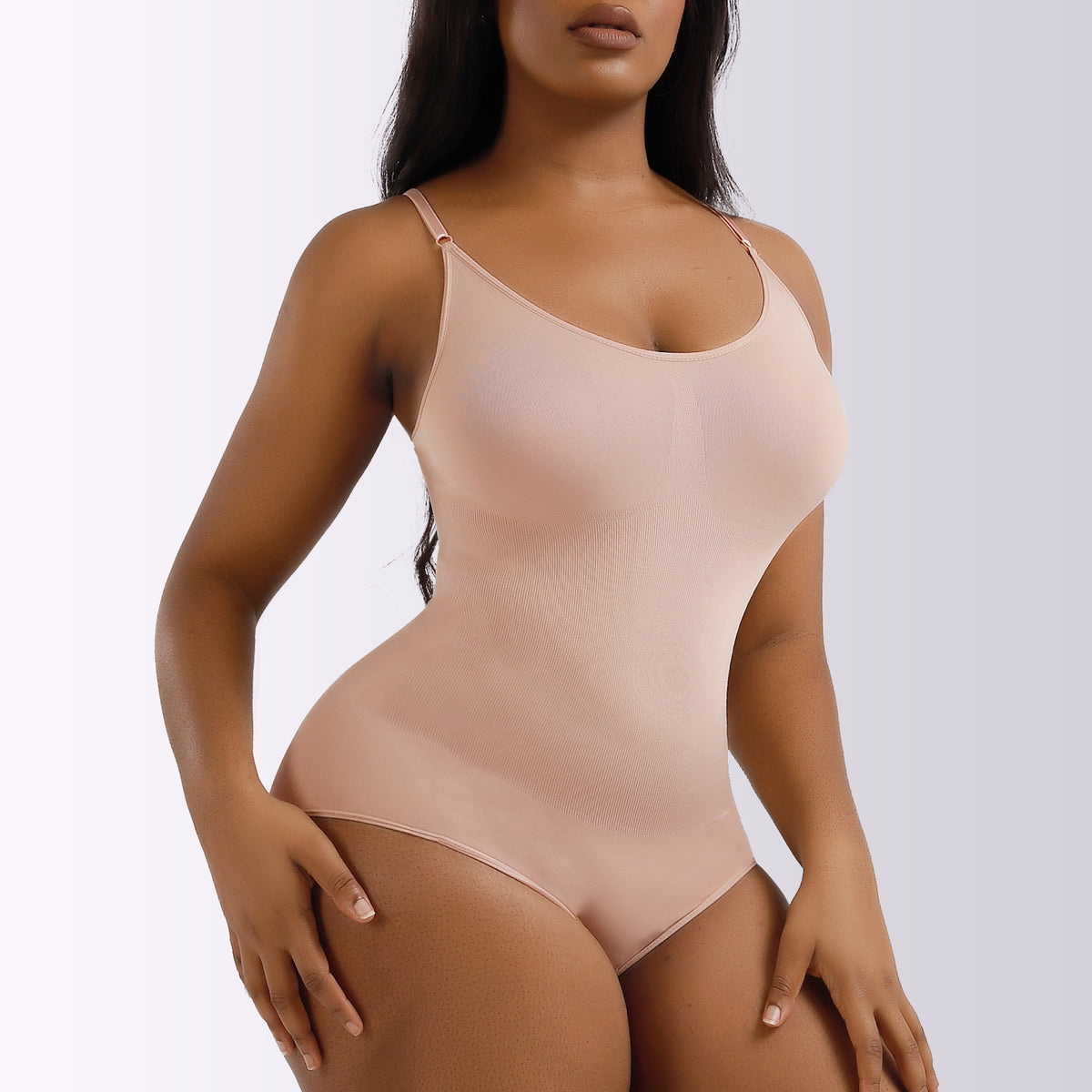 Nude seamless cheeky shaping bodysuit, front view on model