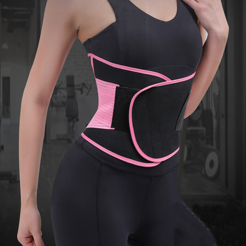 Pink waist trainer belt worn over a black top