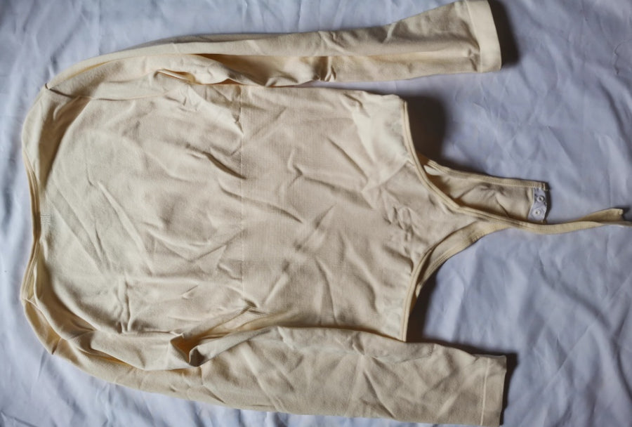 Nude long-sleeve bodysuit, flat view
